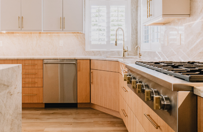 cabinets with white stone countertops in kitchen with subway tile backsplash and wood look flooring